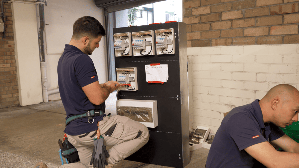 Electrician working on commercial metering and switchboard setup