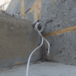 Electrical conduit and cable wiring installed through concrete and block wall