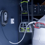 Wall-mounted EV charger installed next to electric car at residential property
