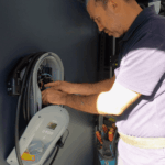 Close-up of electrician wiring a home EV charger unit