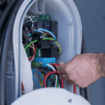 Close-up of electrician completing EV charger wiring and electrical connection