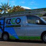 IZCO Electrical Level 2 electrician service van parked on residential street