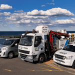 IZCO Electrical Level 2 electrician service vehicles parked near coastal location