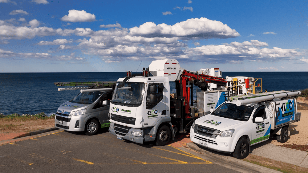 IZCO Electrical Level 2 electrician service vehicles parked near coastal location