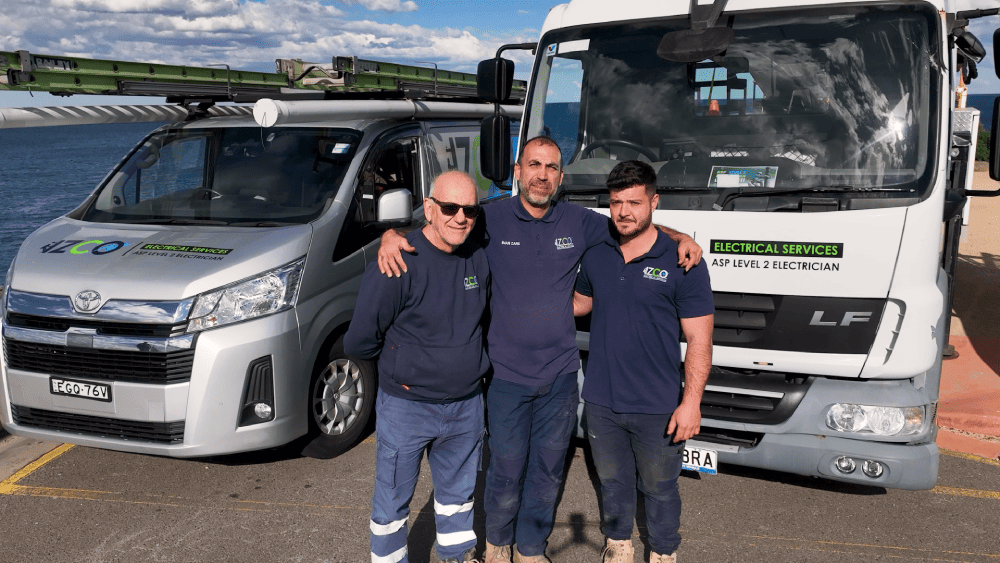 IZCO Electrical Level 2 electricians standing with service vehicles near the coast