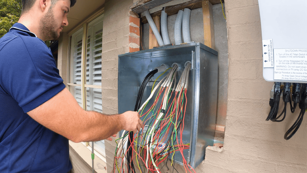 Electrician working on meter box wiring for residential electrical connection