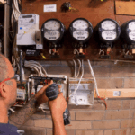 Electrician working on electrical meter installation and wiring