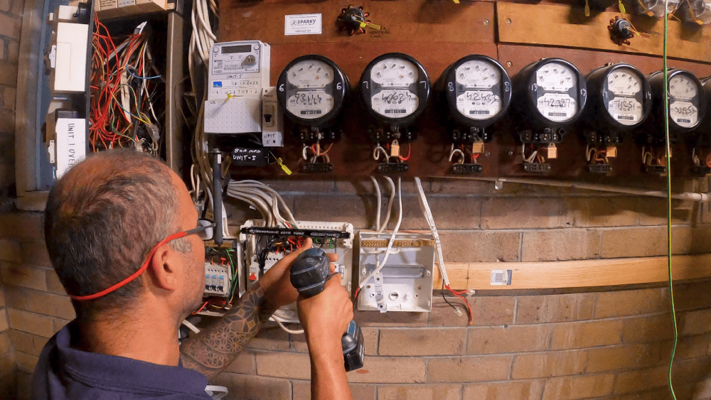 Electrician working on electrical meter installation and wiring
