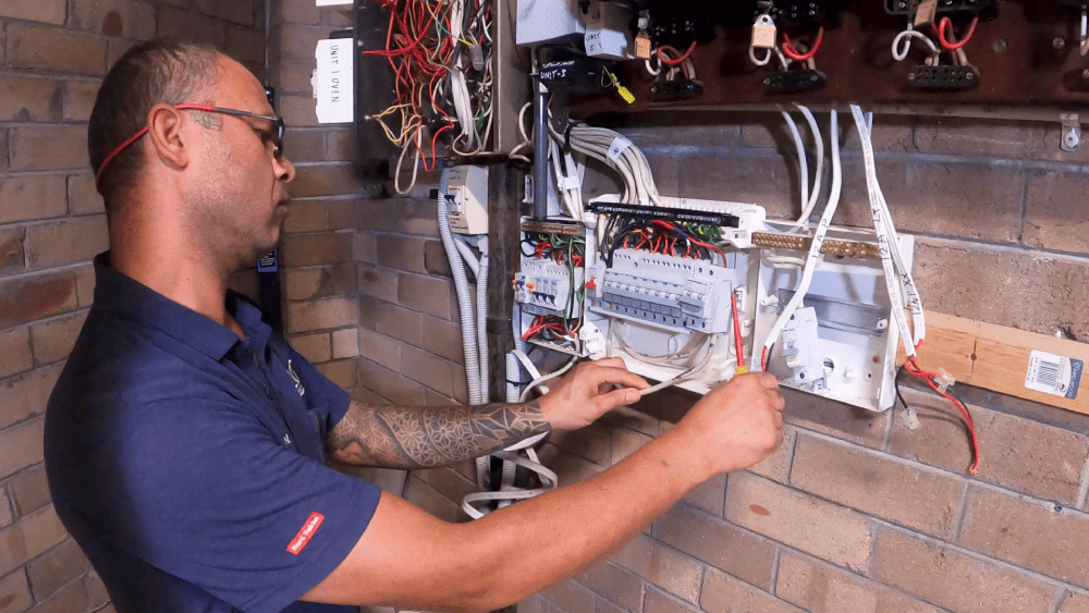 Electrician upgrading electrical meter panel wiring