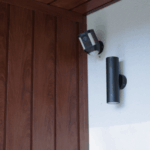 Modern outdoor wall lights installed beside residential front door