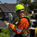 Level 2 electrician repairing overhead electrical cables from elevated platform