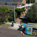 Level 2 electrician repairing overhead powerline from elevated work platform