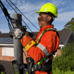 Level 2 electrician repairing overhead service cables on power pole
