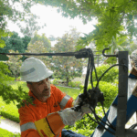 Level 2 electrician repairing point of attachment for overhead power connection