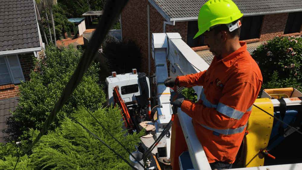 Electrician repairing point of attachment for overhead power supply