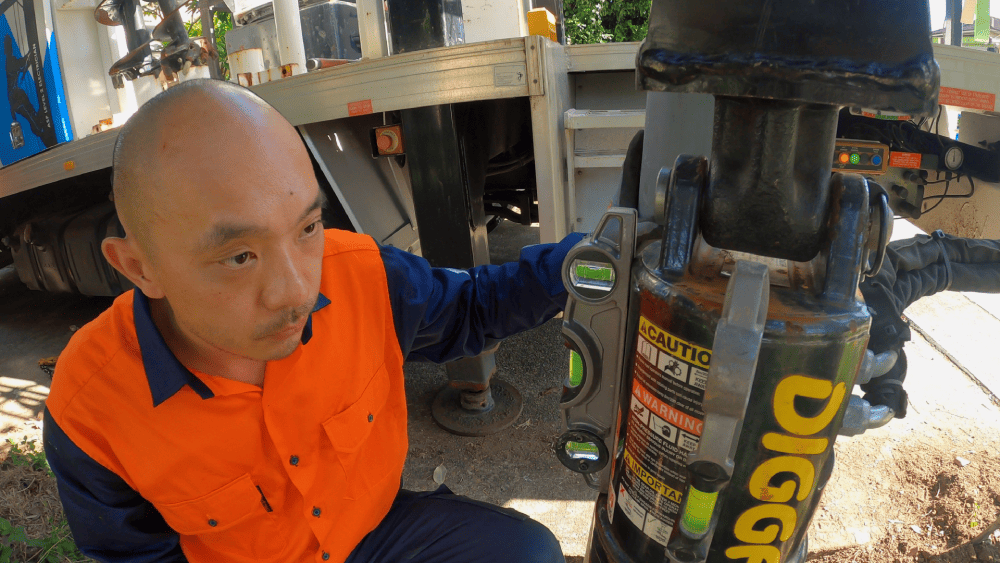 Electrician preparing footing area for private power pole installation