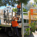 Level 2 electrician preparing private power pole installation with service truck