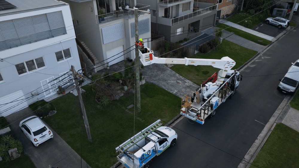 Level 2 electrician working from elevated platform on private power pole
