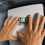 Electrician fitting cover on upgraded switchboard