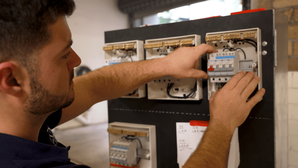 Electrician repairing and checking a switchboard panel