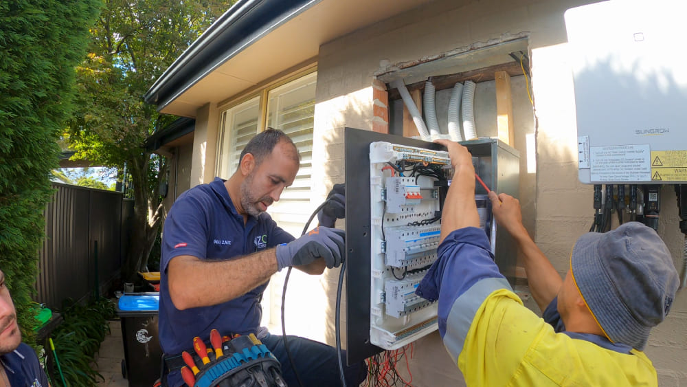 Electricians upgrading residential switchboard and electrical meter panel